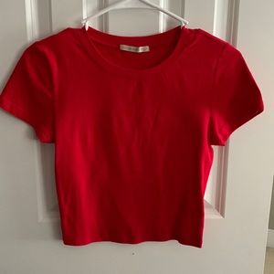 Red basic shirt is slightly cropped and size small!